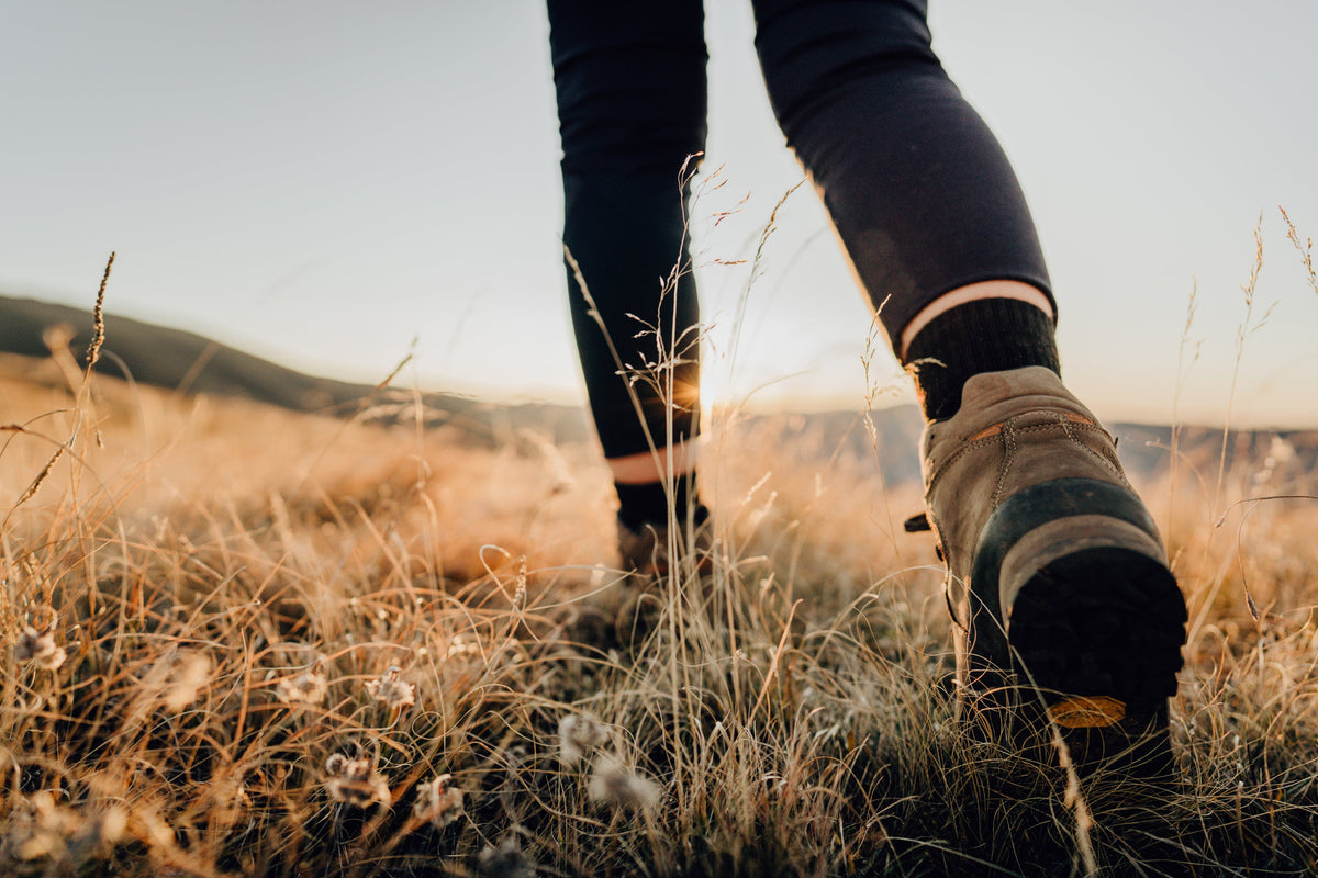 Legs walking through a field wearing socks